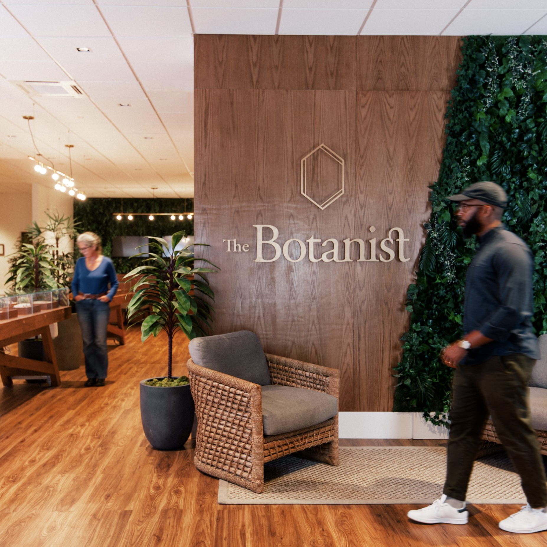 Man walking through Botanist dispensary interior